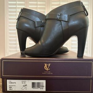 Signature Vince Camuto VI-Nikoletta bootie. Zipper back, strap detail, open toe.
